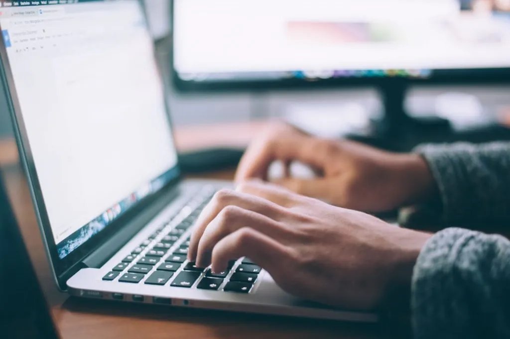 person working on custom database systems on laptop