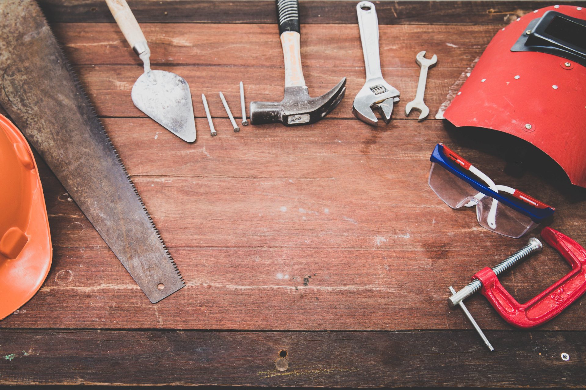 Tools on a wooden table with website maintenance written across