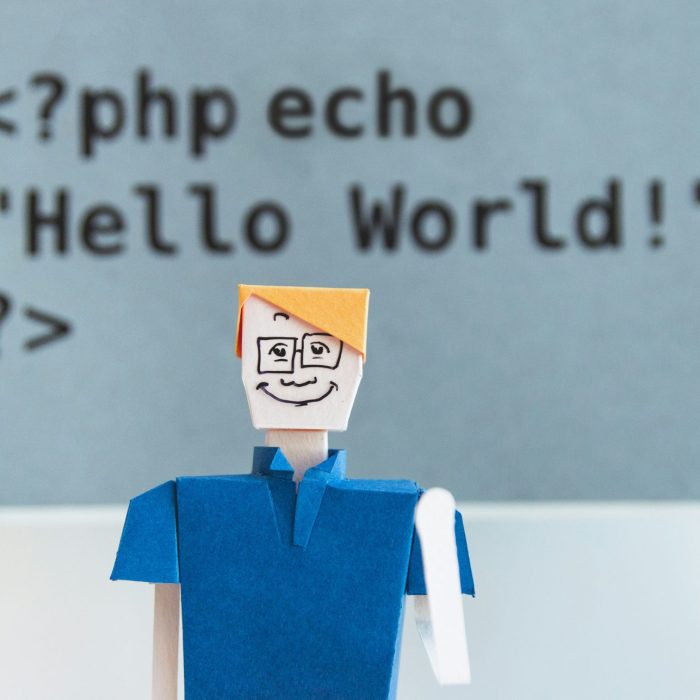 Paper cut-out man waving with PHP Hello world above